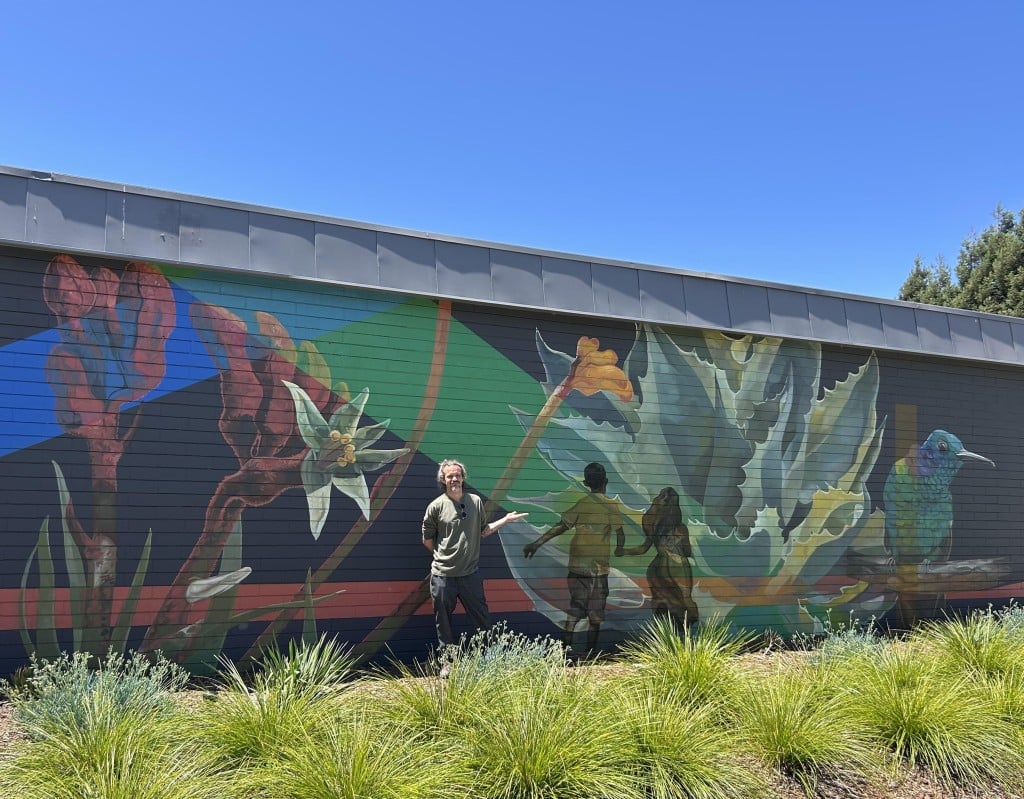 American Canyon artist Sebastien Pridmore in front of the mural he painted for the Napa Valley Community Foundation. Fiona Ulrich photo