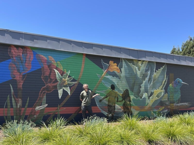 American Canyon artist Sebastien Pridmore in front of the mural he painted for the Napa Valley Community Foundation. Fiona Ulrich photo