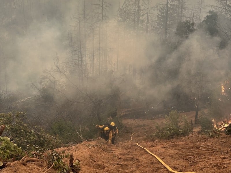 American Canyon Firefighter John Cummings and Firefighter/Paramedic Jack Billeci hike uphill to fight the Pickett Fire. American Canyon Fire Protection District photo.