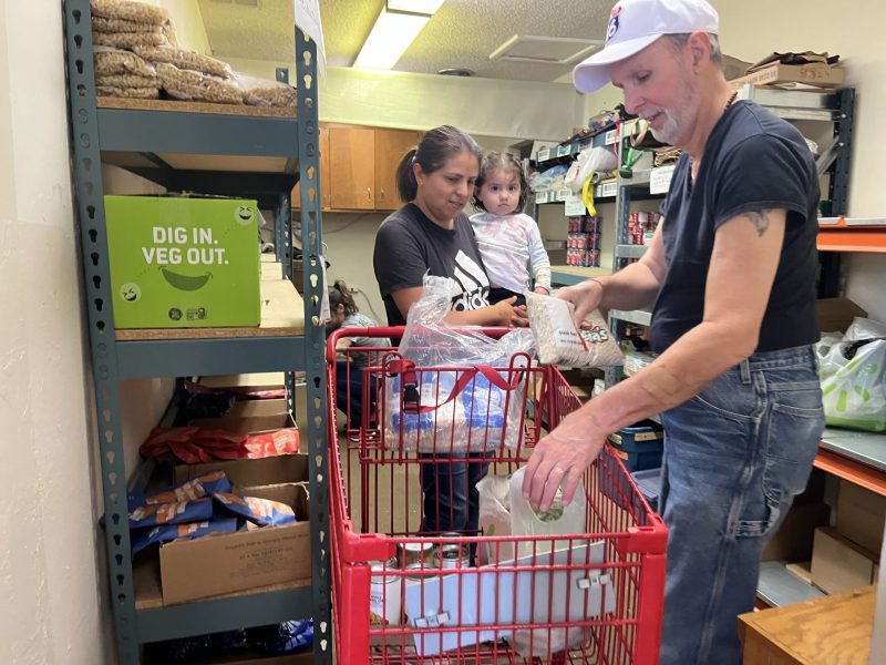 A church volunteer assists a mother and her child. Griffin Jones photo
