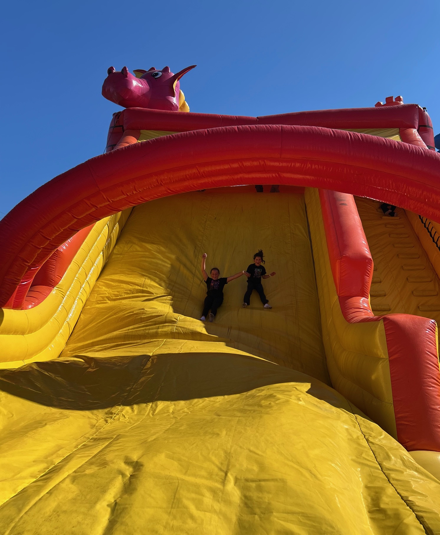 The Gutierrez sisters slid down an inflatable giant slide Saturday at American Canyon's first Hispanic Heritage Day. Kerana Todorov photo
