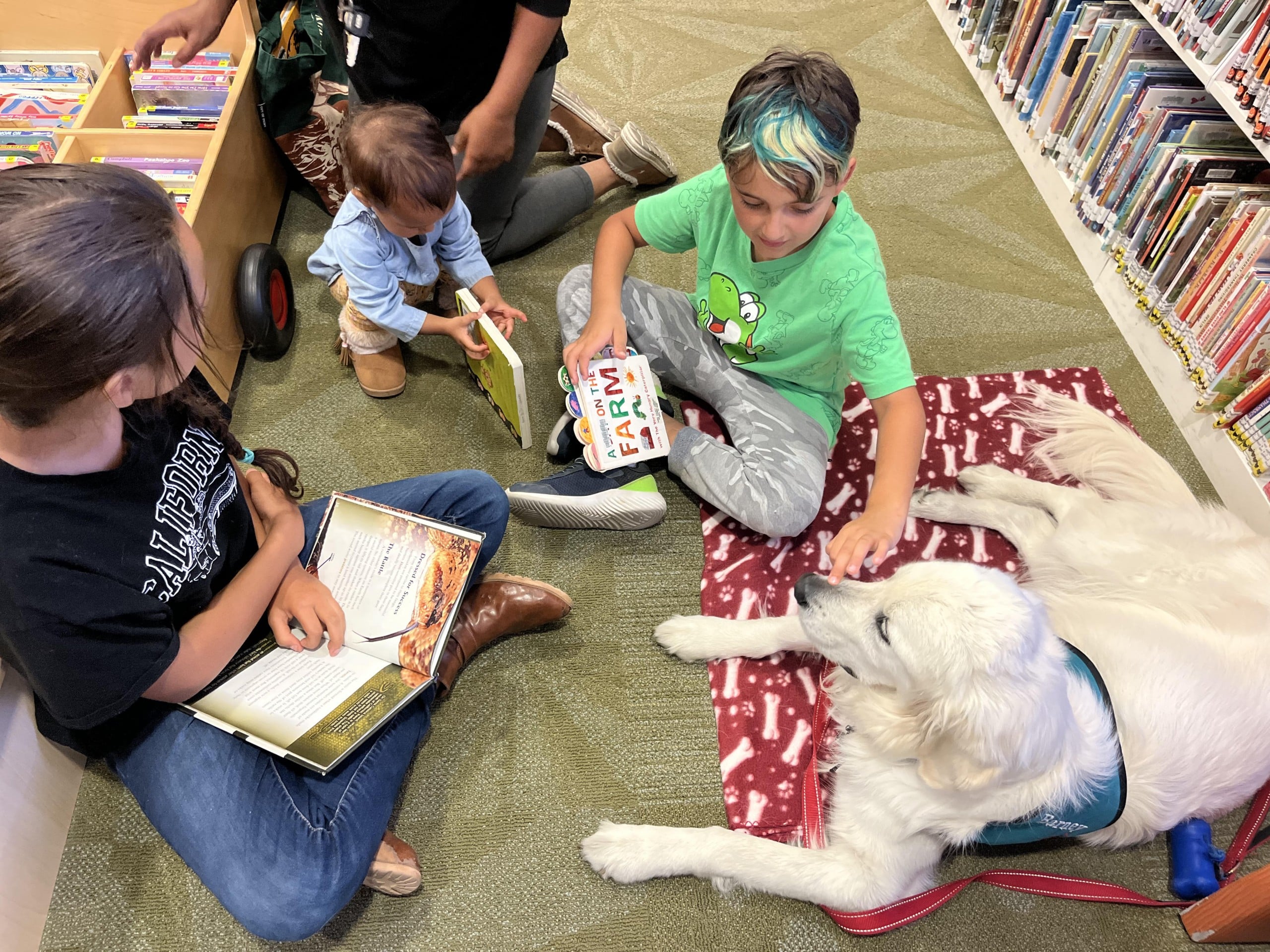 Evie Sanford, left, reads Rattlesnakes to Barney. Griffin Jones photo
