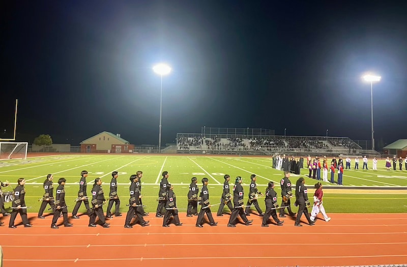 American Canyon High marching band walks onto the Wolf Den stadium field
