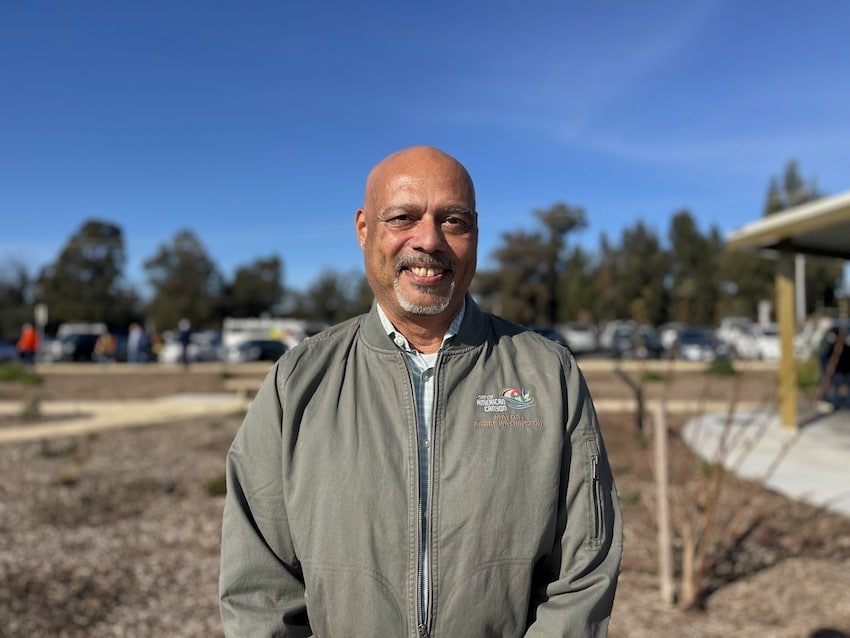 A man standing in the sun at Wetlands Edge Park