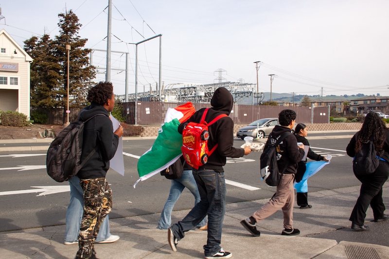 Group of teens walking toward a busy intersection