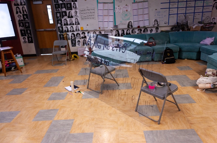 chair with a dry erase board and plans for the musical