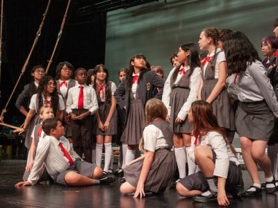 students dressed in costumes on a stage