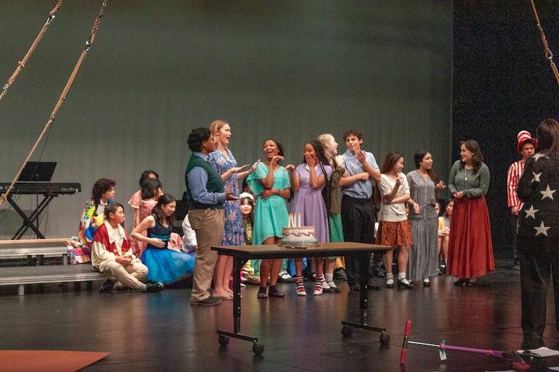 students in costume on a stage