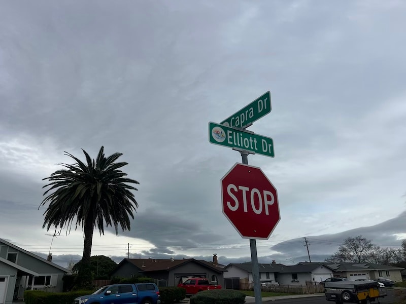stop sign and street signs on a corner