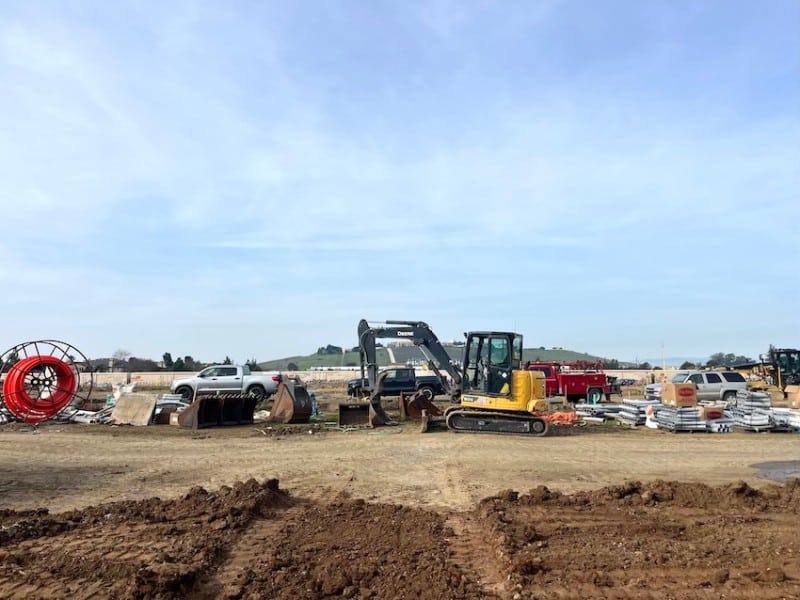 bulldozers and trucks and dirt on a lot