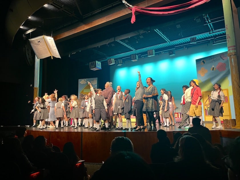 students onstage wearing costumes