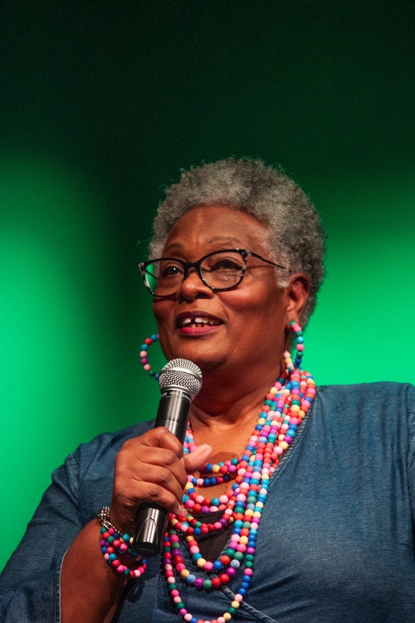 woman holding microphone onstage