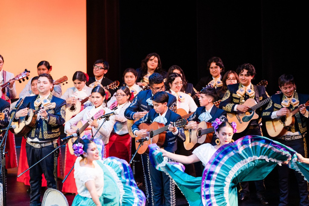a group of people playing music and dancing dressed in traditional mariachi and dance clothes 