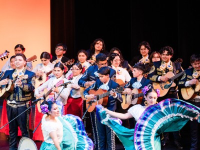 a group of people playing music and dancing dressed in traditional mariachi and dance clothes