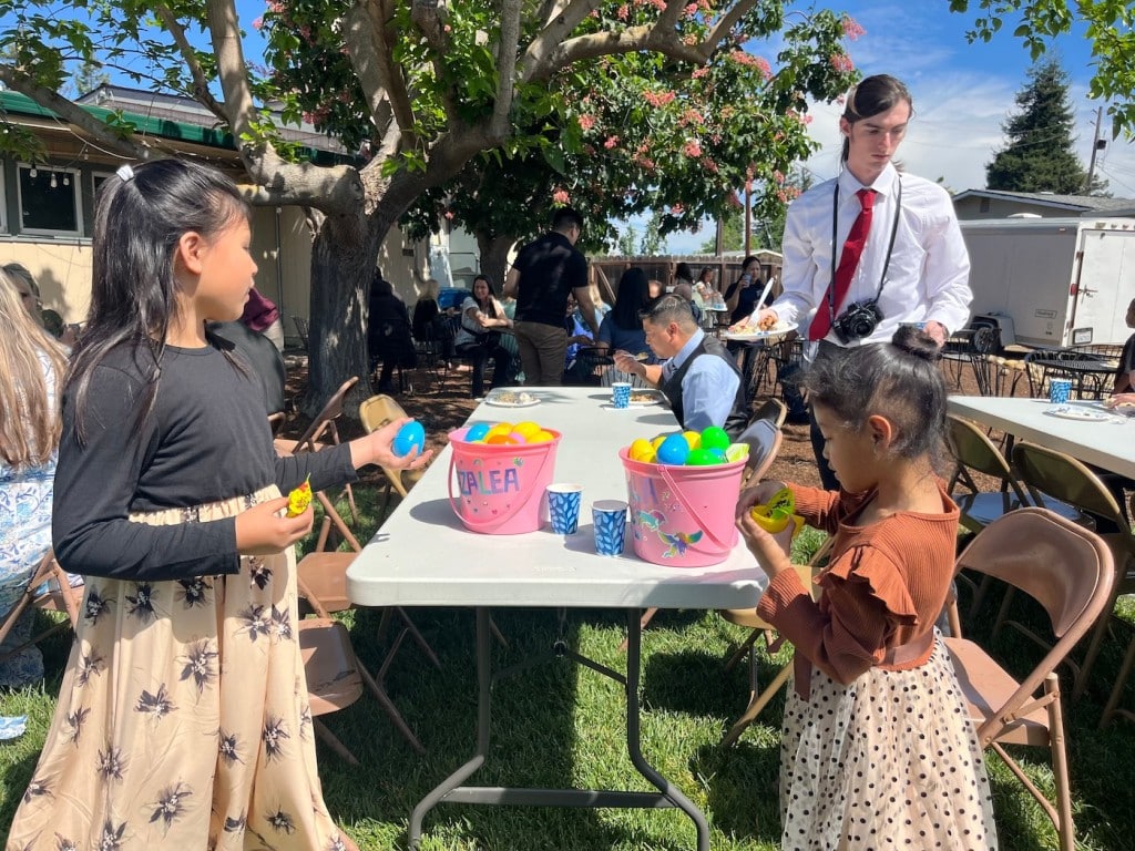 girls looking through their easter eggs ad candy