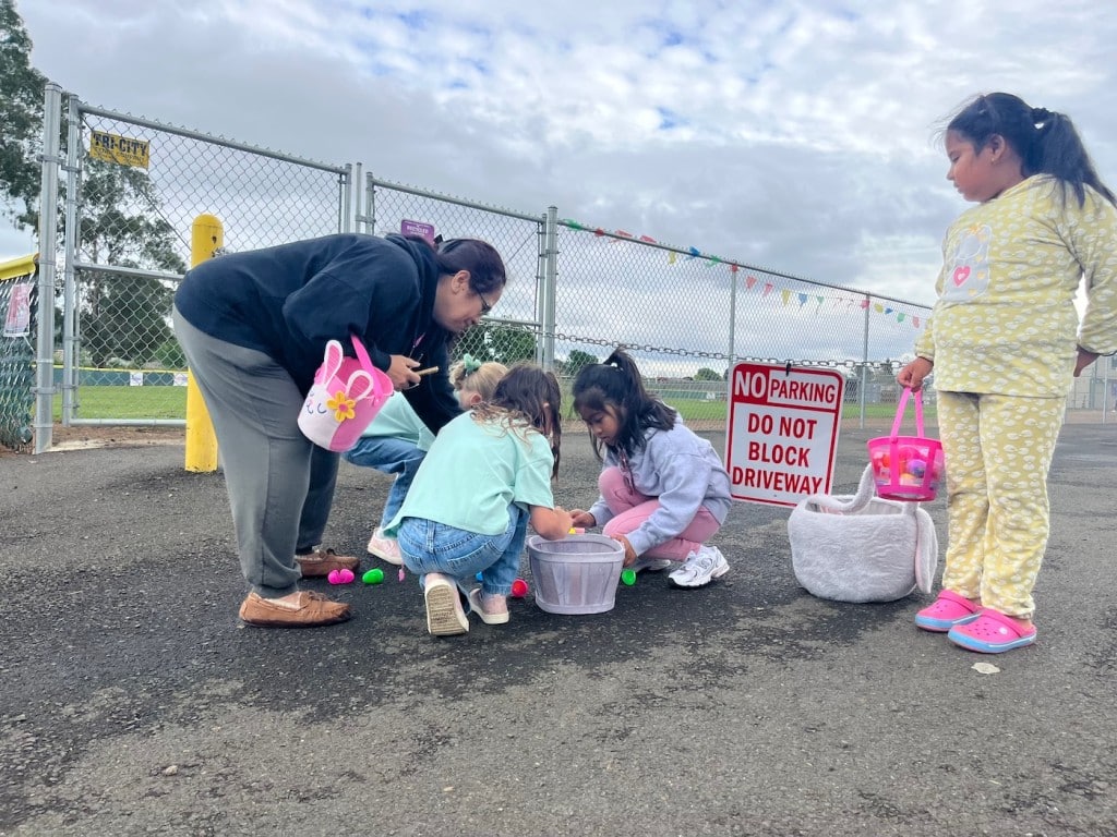 kids picking up easter eggs on foggy day