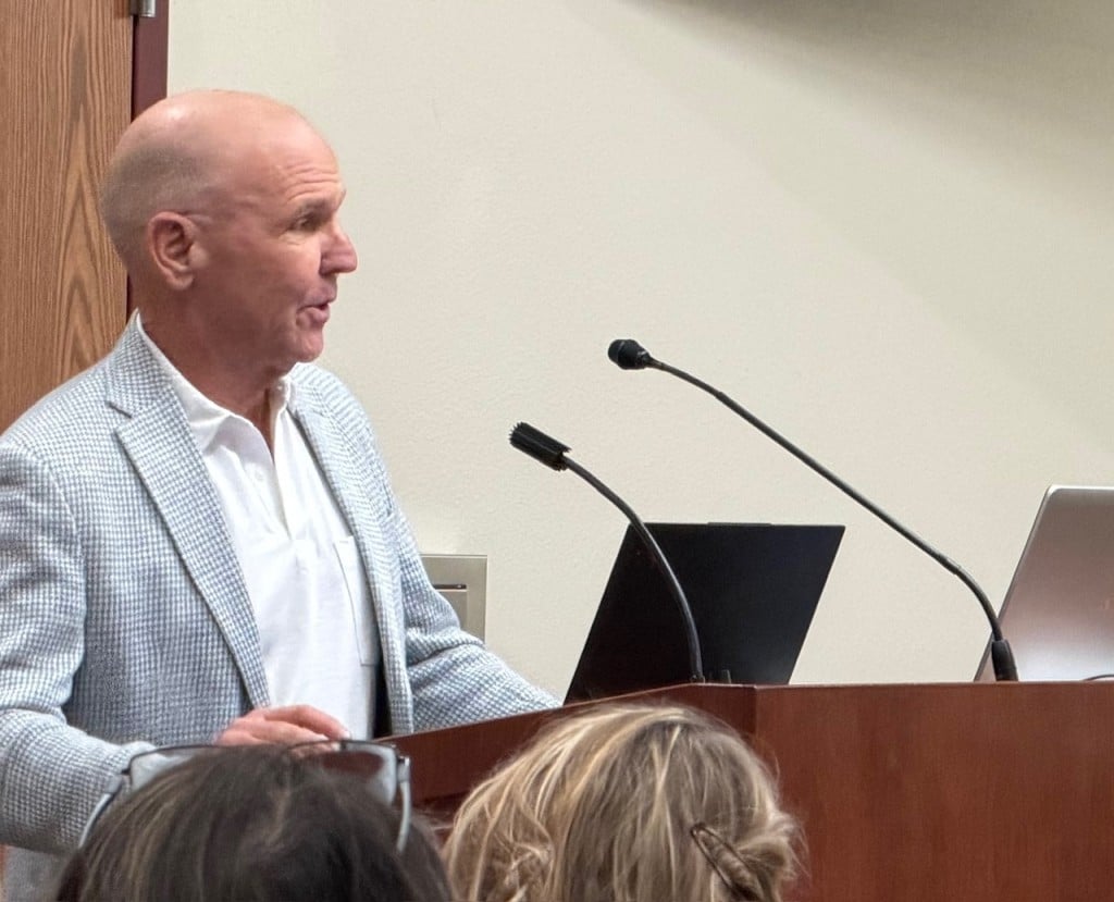 man standing at a podium talking