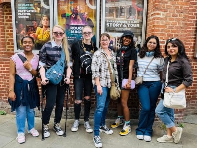 group of teens in front of a theater