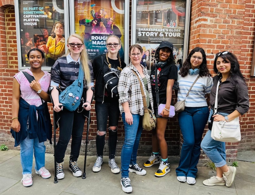 group of teens in front of a theater