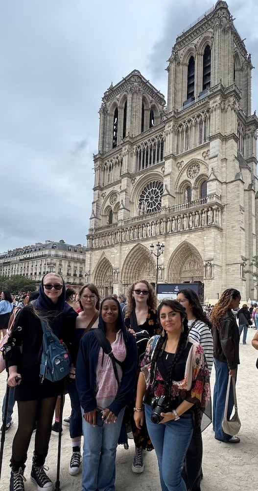 group of teens in front of notre dame