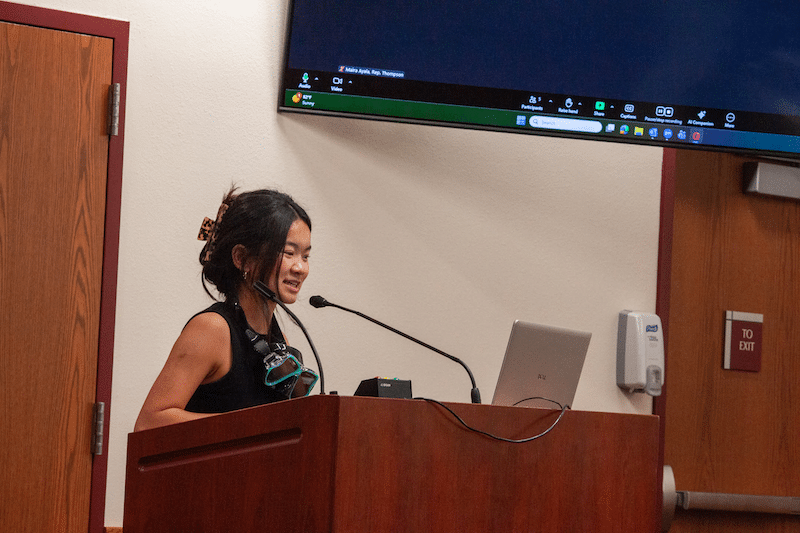 young woman speaking at meeting