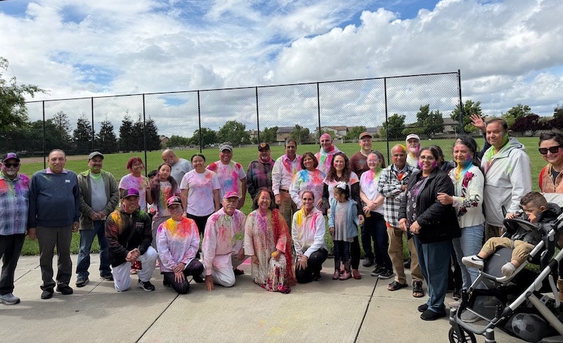 group of people covered in colors
