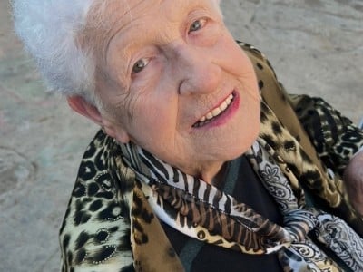 an older woman with white hair and leopard print