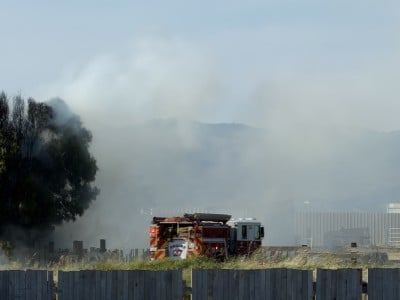 smoke filled air and a tree and fire truck